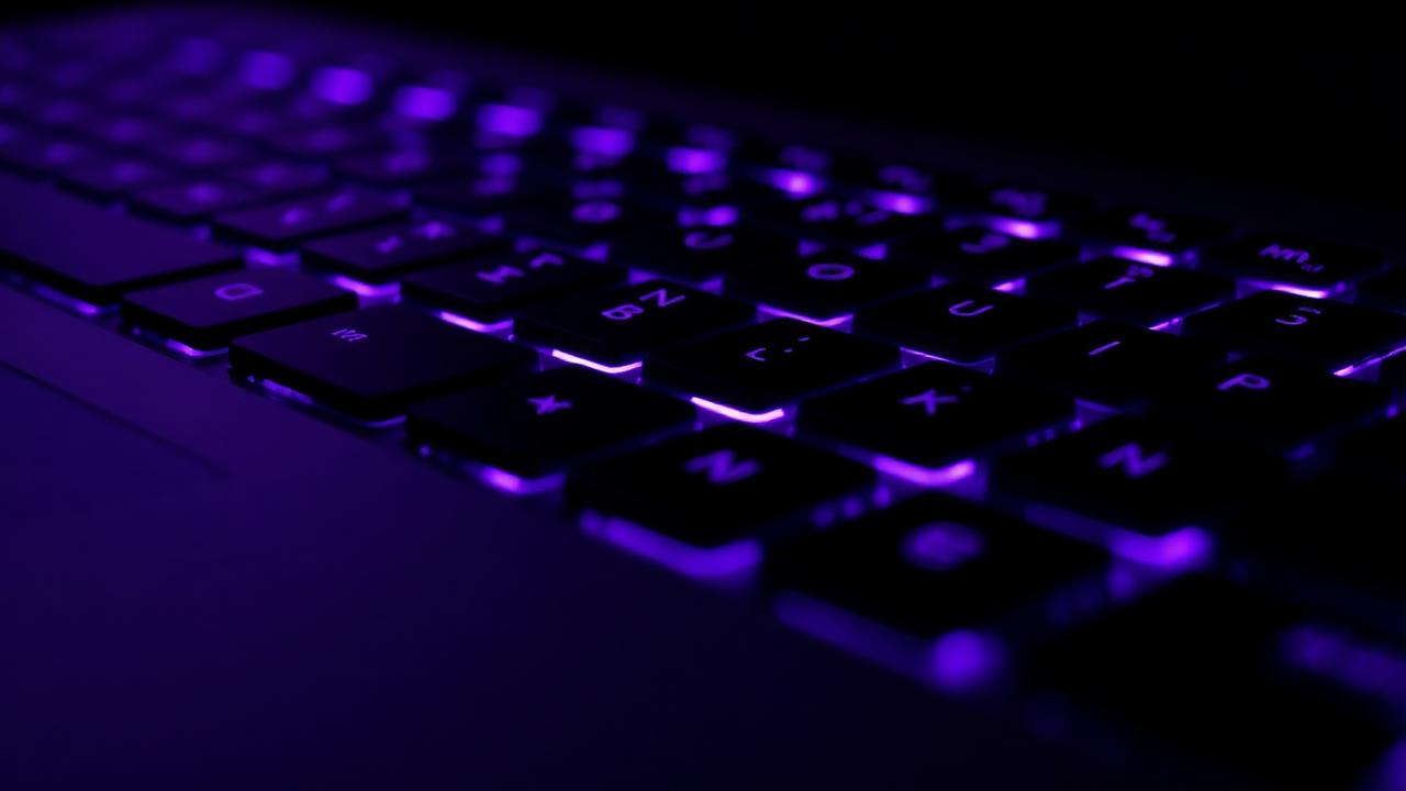 Dark mechanical keyboard with glowing purple keys